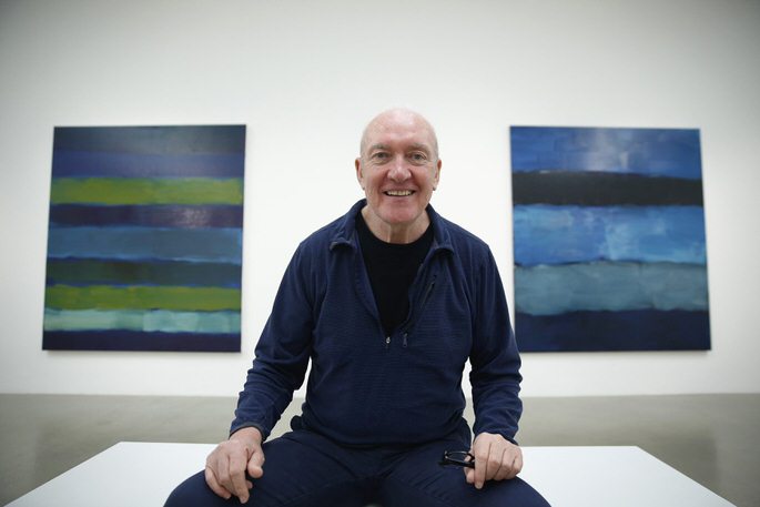 Artist Sean Scully poses with his works "Landline BrAYke 5.14" (L) and "Landline Blue Blue" at the Timothy Taylor Gallery in London November 20, 2014. REUTERS/Luke MacGregor (BRITAIN - Tags: ENTERTAINMENT SOCIETY)